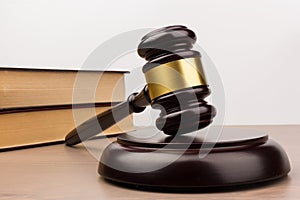 Wooden judges gavel on wooden table, close up. Space for text