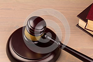 Wooden judges gavel on wooden table, close up. Space for text