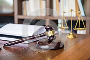 Wooden judges gavel on wooden table on light background, justice