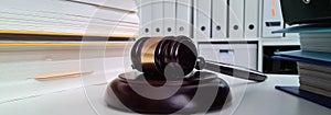 Wooden judicial gavel and folders with papers on table