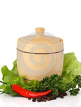 Wooden keg on fresh herbs with spices