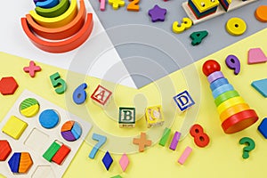 Wooden kids toys on colorful paper. Educational toys blocks, pyramid, pencils, numbers. Toys for kindergarten,