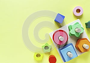 Wooden kids toys on colourful paper. Educational toys blocks. Toys for kindergarten, preschool or daycare.