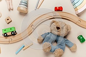 Wooden kids toys on pastel paper. Educational toys blocks, pyramid, pencils, bear, bunny, train. Toys for kindergarten