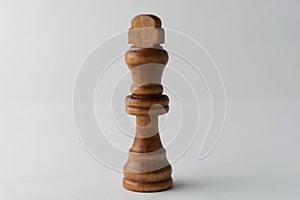 Wooden king chess figure on grey background