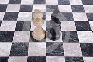 Wooden kings on chessboard