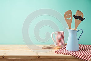 Wooden kitchen counter with kitchen utensils in jug. Product montage display background or mock up