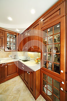 Wooden kitchen cupboards, sink and kitchen countertops.