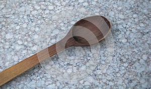 Wooden kitchen spoon on stone countertop