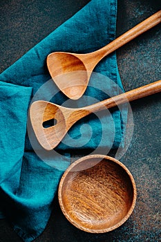 Wooden kitchen tools and bowl with blue linen napkin