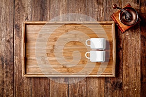 Wooden kitchen tools on dark brown table background.