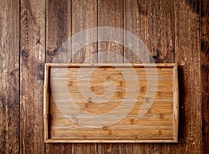 Wooden kitchen tools on dark brown table background.