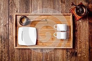 Wooden kitchen tools on dark brown table background.