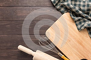 Wooden kitchen tools and napkin on the wooden background