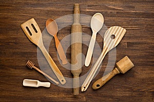 Wooden kitchen tools on vintage wooden background