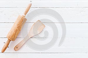 Wooden kitchen utensils on white  wooden background