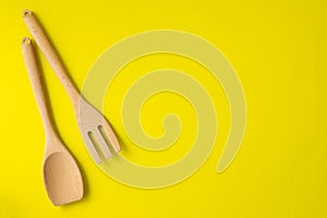 Wooden kitchenware on yeloow background