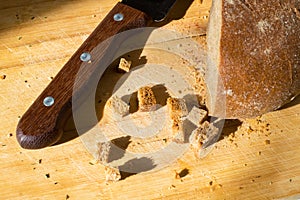 Wooden knife handle and sliced bread on the table