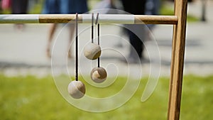 Wooden ladder golf balls hang on wooden bar on a sunny day