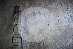 Wooden ladder leaning against textured wall. The concept of the career ladder