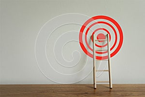 Wooden ladder with red target achievement, Business growth up and successful concept. Goal success stock market . Aiming