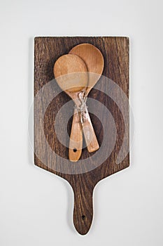 Wooden ladles on a dark wooden cutting board