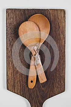 Wooden ladles on a dark wooden cutting board