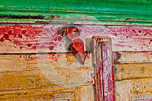 Wooden latch on the color door of an old wardrobe