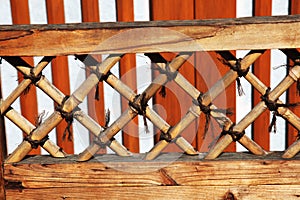 Wooden lattice in brown tied together with string