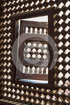 Wooden latticed window Mashrabiya with one small swinging sash, Cairo, Egypt photo