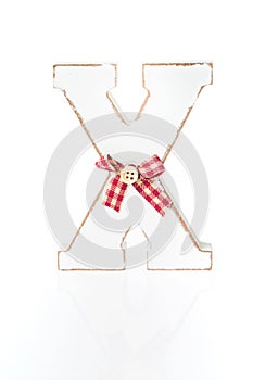 Wooden letter X decorated in Christmas spirit