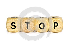 Wooden letter dice forming the word `Stop` on white background