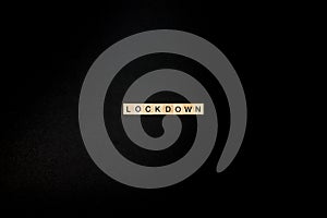 Wooden letters on a black background forming the word â€œlockdownâ€. Second wave during Coronavirus pandemic concept