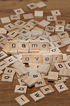 Wooden letters composing the words `game over`