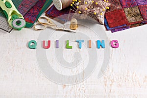 Wooden letters, consisting to the word quilting, accessories for quilting above the word, space for text