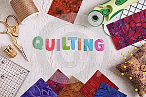 Wooden letters, consisting to the word quilting surrounded by accessories for quilting