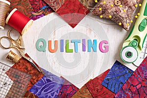 Wooden letters, consisting to the word quilting surrounded by accessories for quilting