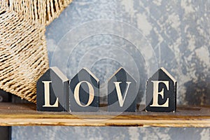 Wooden letters forming word LOVE written on concrete background