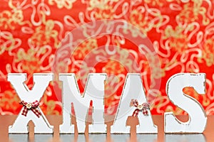 Wooden letters forming word XMAS with ribbons