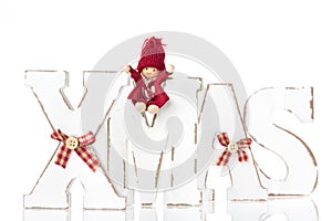 Wooden letters forming word XMAS with ribbons and red figures be