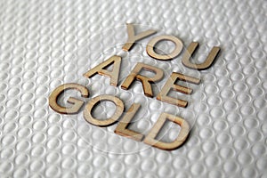 Wooden letters forming the words You Are Gold for everyone