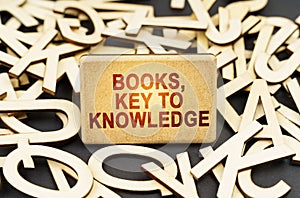 Among the wooden letters is a sign with the inscription - Books, key to knowledge