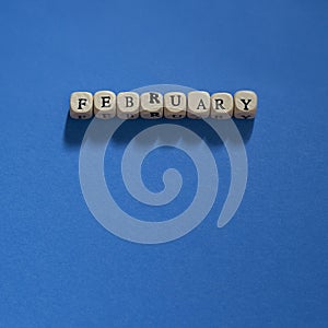 Wooden letters spelling February on a Dark Blue background
