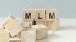 Wooden letters spelling MLM, management