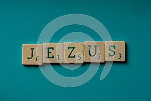 Wooden letters spelling the word Jezus on a blue background.