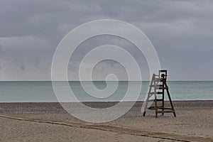 A wooden lifeguard chair on lonely beach