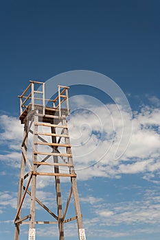 Wooden lifesaving tower with clouds in background