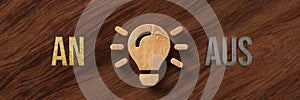 Wooden lightbulb with the German words for ON and OFF - 3d illustration