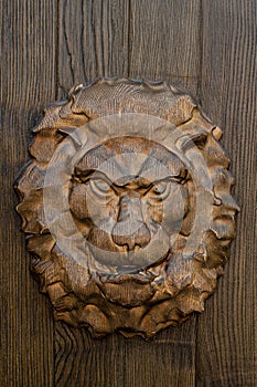 Wooden lion head on the gate