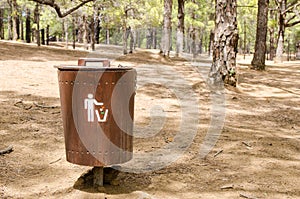 Wooden litter bin in the forest.